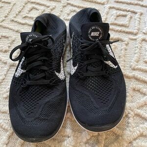 Black Nike running shoes, size 9